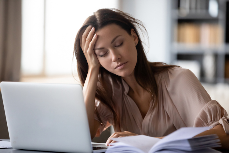 Tired millennial girl student sit at desk fall asleep studying late hours at laptop at home, exhausted young woman take nap sleep at workplace working on computer, exhaustion, fatigue concept